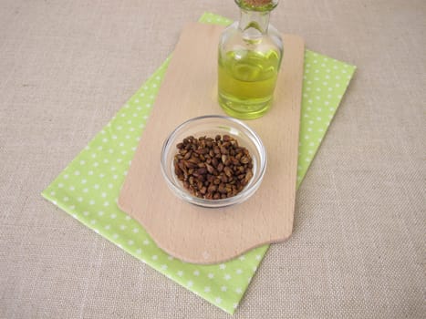 Healthy grape seed oil from grapeseeds in a glass bottle