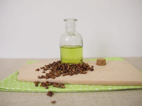 Healthy grape seed oil from grapeseeds in a glass bottle