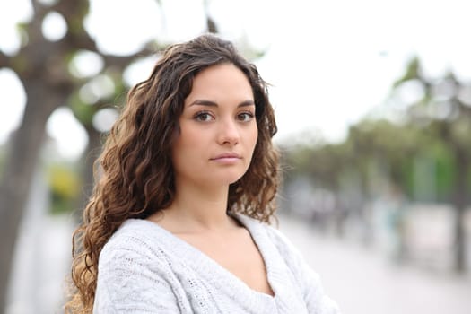 Serious woman looking at camera in the street