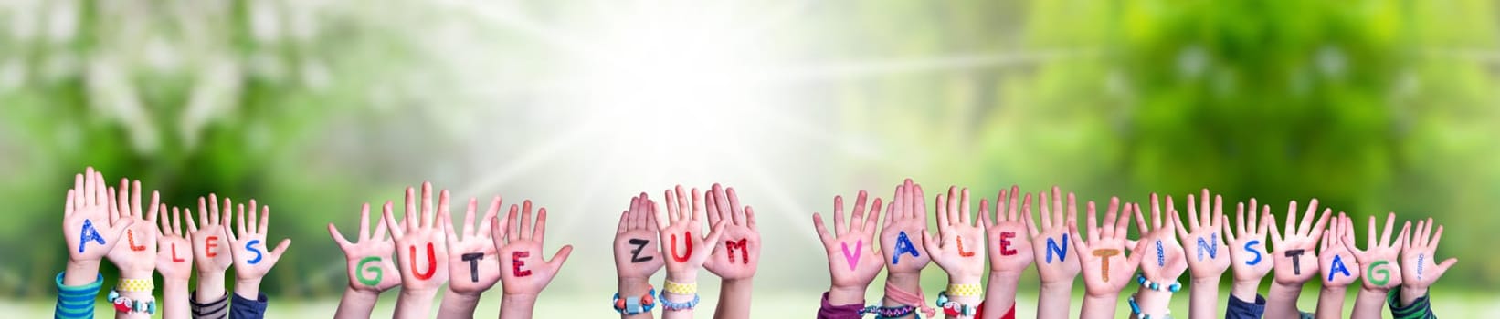 Children Hands Building Colorful German Word Alles Gute Zum Valentinstag Means Happy Valentines Day. Sunny Green Grass Meadow As Background