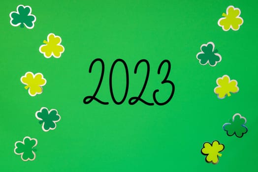 Flat Lay With Text 2023. Green Paper Background With Saint Patrick's Day Decoration.
