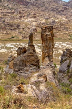 Rock formation in Isalo National Park in Ihorombe Region. Wilderness landscape with water erosion into rocky outcrops like in Utah, plateaus, extensive plains and deep canyons. Madagascar landscape.