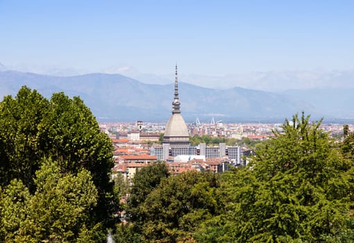 Turin - Italy - Urban skyline with Mole Antonelliana building, blue sky and Alps mountains