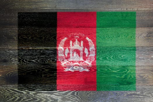 An Afghanistan flag on rustic old wood surface background