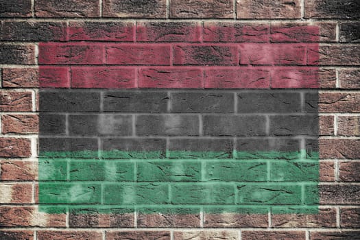 An African American flag on a brick wall background