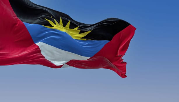 Antigua and Barbuda national flag waving on a clear day. Antigua and Barbuda is an island state of Central America. Rippled fabric. Realistic 3d illustration