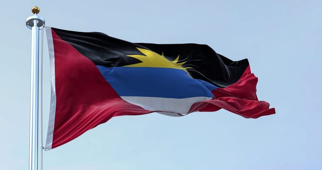 Antigua and Barbuda national flag waving on a clear day. Antigua and Barbuda is an island state of Central America. Rippled fabric. Realistic 3d illustration