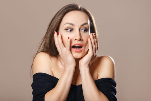 Extremely surprised young woman