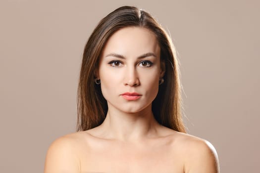 Medium closeup portrait of serious woman with healthy skin