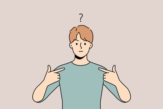Frustrated young man feel confused point at himself. Unhappy guy feeling anxious showing with finger at him. Confusion and frustration.
