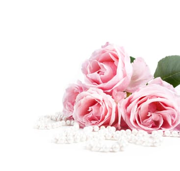 Beautiful pastel pink roses bunch and elegant bridal pearls isolated over white background. Wedding flower bouquet arrangement and classy jewelry. Bright soft clean reception invitation card and banner design.