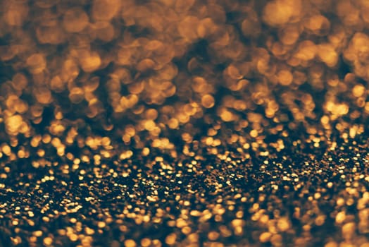 Blur neon gold light circle background. Sparkling firework bokeh dots in retro film filter style. Luxury and classy new year and christmas celebration party textured backdrop. Blurry golden dust particles.