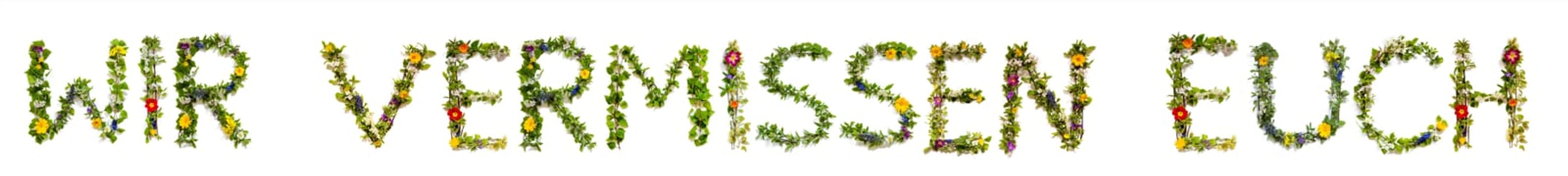 Blooming Flower Letters Building German Text Wir Vermissen Euch Means We Miss You. Summer And Spring Season Blossoms And Flower Lei.