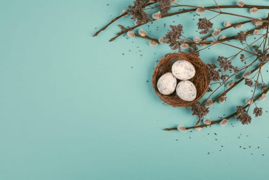 Easter holiday background, nest with small eggs, branches of pussy willow, greeting card, spring season
