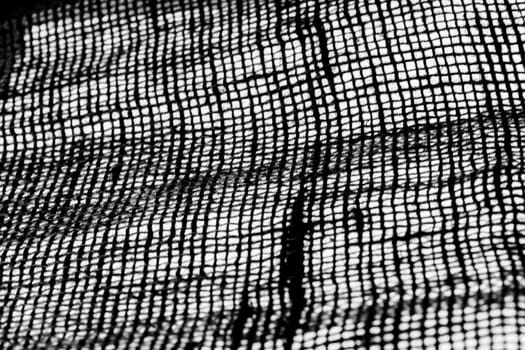 Studio shot close-up of frame-filling coarse burlap in black and white implementation.