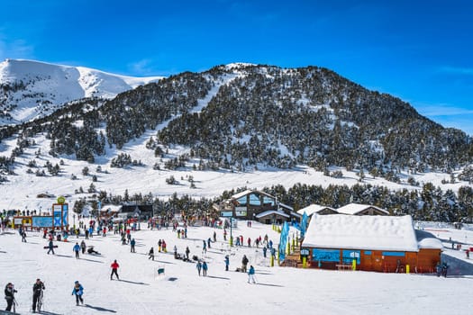 El Tarter, Andorra, Jan 2020 View on bars, restaurants and meeting points, ski slopes, mountains and forest. People enjoying winter ski holidays