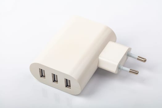 White USB Power Socket with three usb charging connectors over bright background