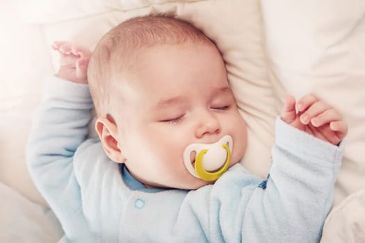 Cute three month old baby sleeping in comfortable bed. Concept of the family andparenting.