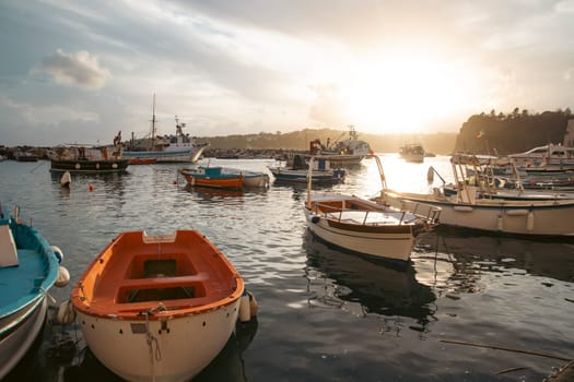 View of the Port of Corricella with lots of colorful houses on a sunny day in Procida Island, Italy.
