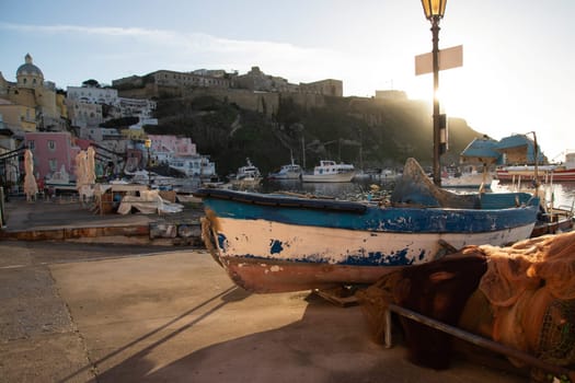 View of the Port of Corricella with lots of colorful houses on a sunny day in Procida Island, Italy.