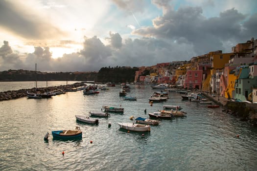 View of the Port of Corricella with lots of colorful houses on a sunny day in Procida Island, Italy.