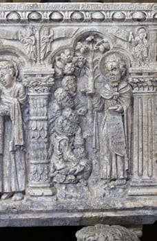 Massa Marittima, Italy - Sept 11, 2022:  Monumental baptismal font, with a rectangular bath surmounted by a small temple. The baptistery dates from 1267. Cathedral of Saint Cerbonius in Massa Marittima. Italy