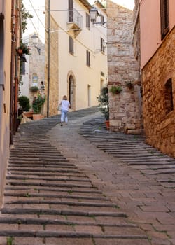 Massa Marittima, Italy - Sept 11, 2022: Steep and narrow street in old town of Massa Marittima, Italy