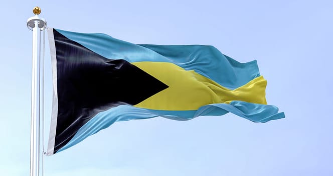 Close-up view of the Bahamas national flag waving in the wind. Black triangle on hoist, aquamarine-gold-aquamarine horizontal bands. Rippled fabric. Textured background. Realistic 3d illustration