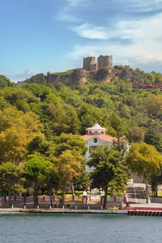Green mountains of Bosphorus Strait at Anadolu Kavagi, with ruins of Yoros Castle, Yoros Kalesi, or Genoese Castle, at the far end, an ancient Byzantine castle at the confluence, Istanbul, Turkey