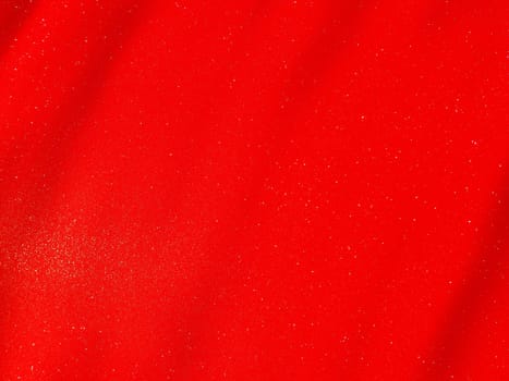 Red background, arched scarlet. Nice holiday color. Background with shimmer, gradient, white dots. Photograph of sparkling colored paper