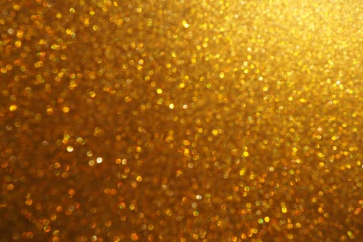 Bokeh light of gold glitters. Golden glitter texture background. Sparkling glitter wrapping paper with sequins and sparkles. Festive golden bokeh and glitter. Beautiful background