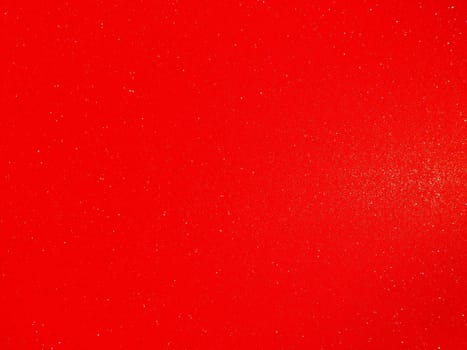 Red background, arched scarlet. Nice holiday color. Background with shimmer, gradient, white dots. Photograph of sparkling colored paper