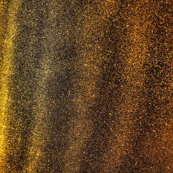 Bokeh light of gold glitters. Golden glitter texture background. Sparkling glitter wrapping paper with sequins and sparkles. Festive golden bokeh and glitter. Diagonal stripes and waves.