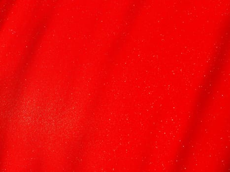Red background, arched scarlet. Nice holiday color. Background with shimmer, gradient, white dots. Photograph of sparkling colored paper