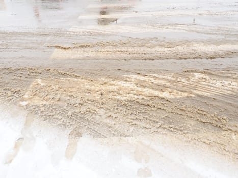 Snow, ice, slush and winter mud at a pedestrian crossing. The air temperature is about 0. Difficult driving conditions. Braking distance of the car. Traffic Laws. Infrastructure and road services.