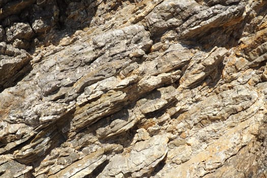 Flysch is a series of marine sedimentary rocks that are predominantly clastic in origin and are characterized by the alternation of lithological layers. Balkans, Montenegro, Budva, Mogren beach.
