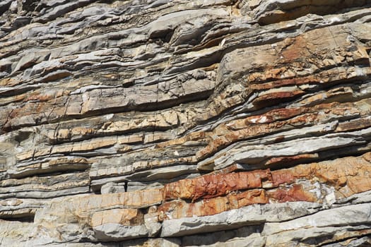 Flysch is a series of marine sedimentary rocks that are predominantly clastic in origin and are characterized by the alternation of lithological layers. Balkans, Montenegro, Budva, Mogren beach.