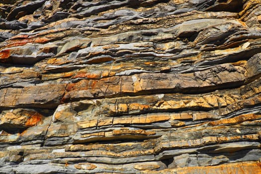 Flysch is a series of marine sedimentary rocks that are predominantly clastic in origin and are characterized by the alternation of lithological layers. Balkans, Montenegro, Budva, Mogren beach.