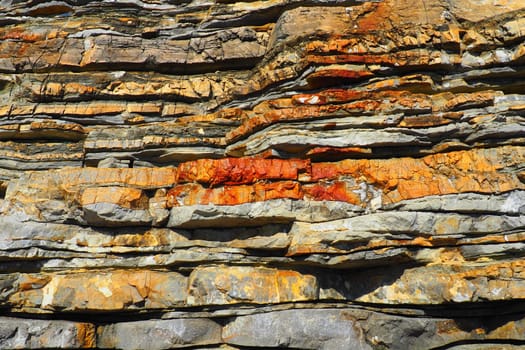 Flysch is a series of marine sedimentary rocks that are predominantly clastic in origin and are characterized by the alternation of lithological layers. Balkans, Montenegro, Budva, Mogren beach.