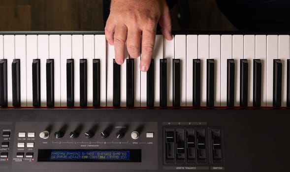 Male Hands Practicing on the Electronic Piano Keyboard.