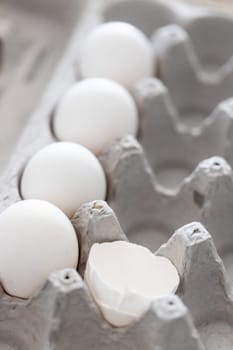 Carton of White Chicken Eggs and Egg Shells.