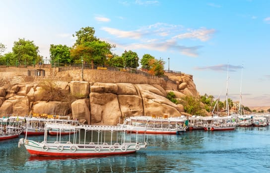 Traditional colorful egyptian boats in the Nile near the banks of Aswan, Egypt.