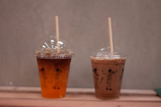 Black coffee with orange juice and iced mocha on wooden table, stock photo