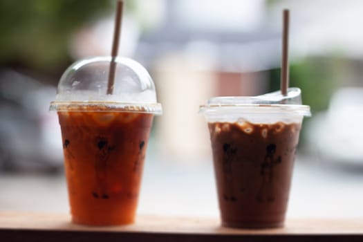 Black coffee with orange juice and iced mocha on wooden table, stock photo