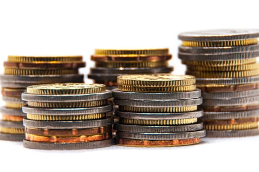 Close up of coins on white background with customizable space for text or ideas. Business and investment concept.
