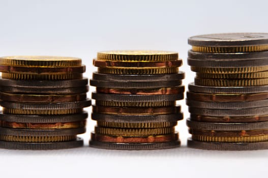 Close up of coins on white background with customizable space for text or ideas. Business and investment concept.