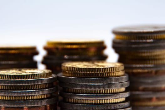 Close up of coins on white background with customizable space for text or ideas. Business and investment concept.