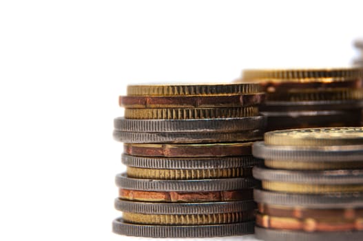 Close up of coins on white background with customizable space for text or ideas. Business and investment concept.