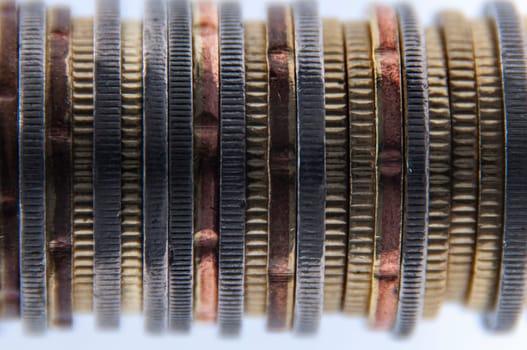 Close up of coins on white background with customizable space for text or ideas. Business concept.