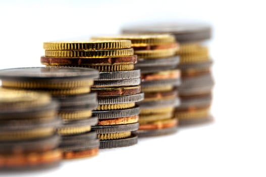 Close up of coins on white background with customizable space for text or ideas. Business and investment concept.